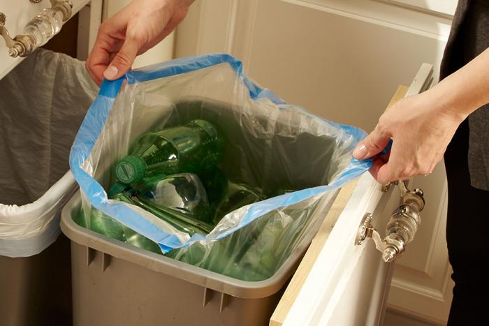 Clear recycling bag in kitchen trash container.