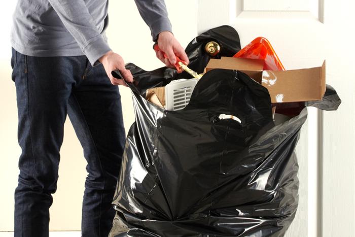 Person filling a load and carry contractor bag.