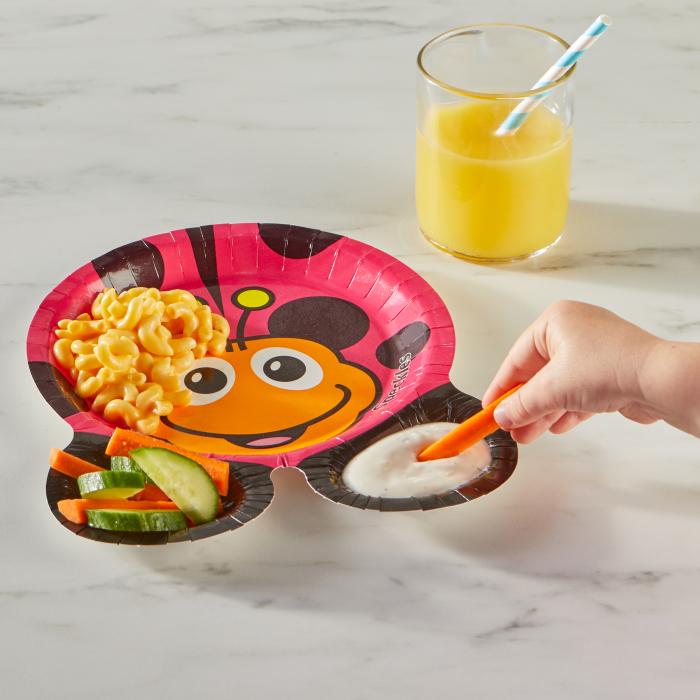 Child dipping a carrot in ranch using a Hefty Zoo Pals ladybug plate