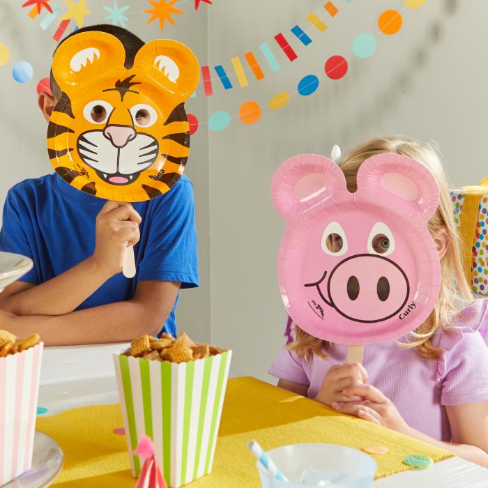 Two children at a birthday party using Hefty Zoo Pals plates as masks