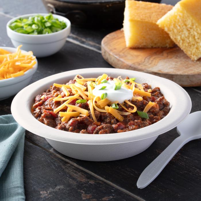 ECOSAVE 16oz bowl filled with chili and topped with shredded cheese and sour cream