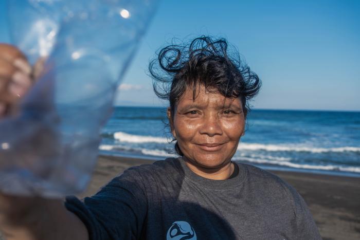 Women holding a plastic bottle on the beach
