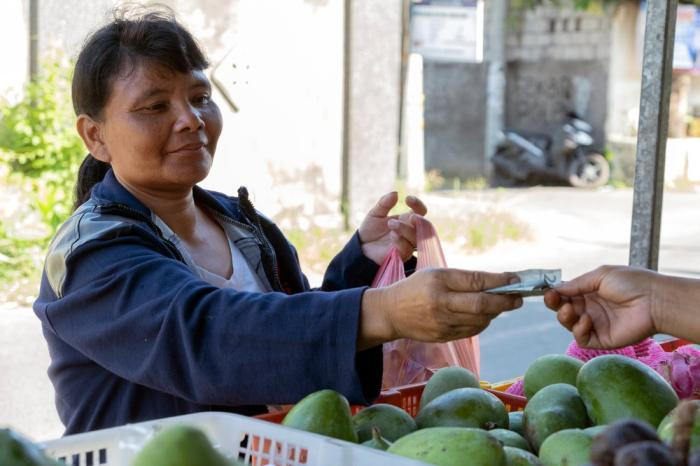 Plastic bank employees shopping for food at a market