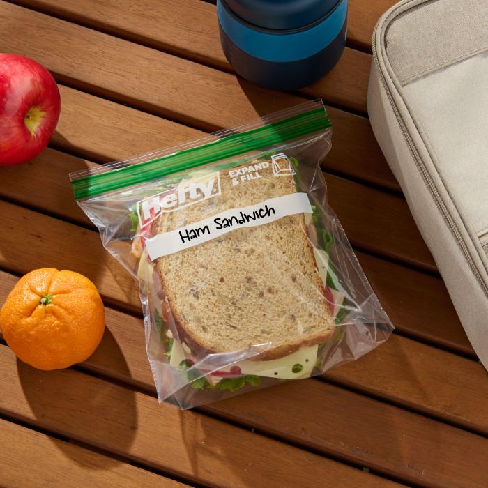 Ham sandwich in a sealed Hefty press to close sandwich bag on an outdoor picnic table