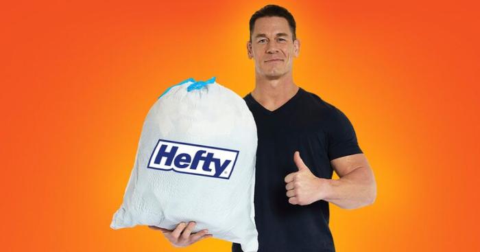 John Cena holding a white Hefty trash bag