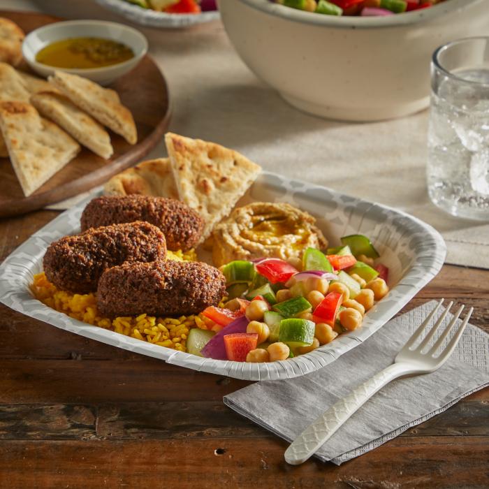 Hefty ECOSAVE fork sitting alongside a plate of Mediterranean food