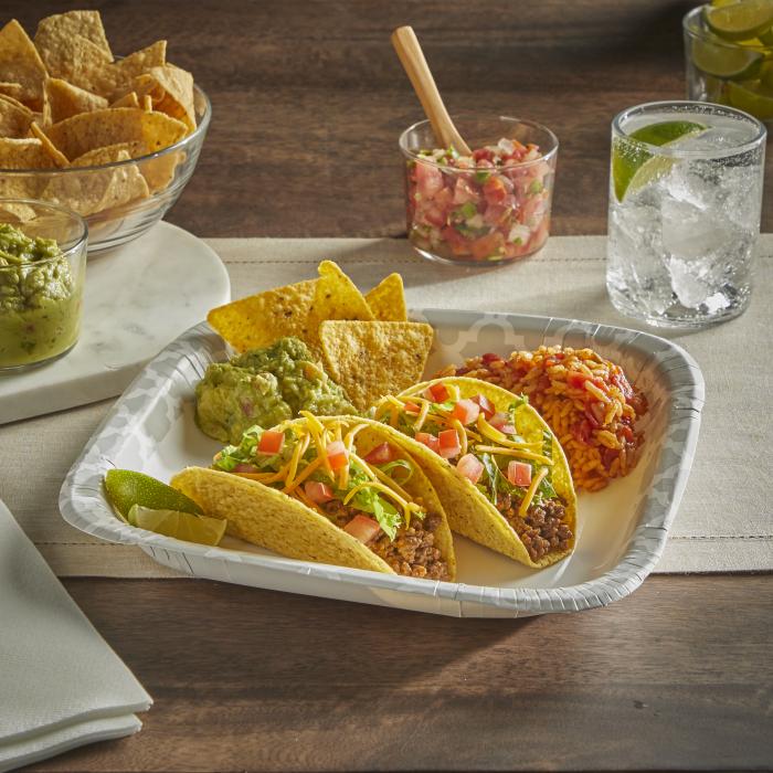 Hard shell tacos, rice and guac and chips on a Hefty Extra Deep paper plate