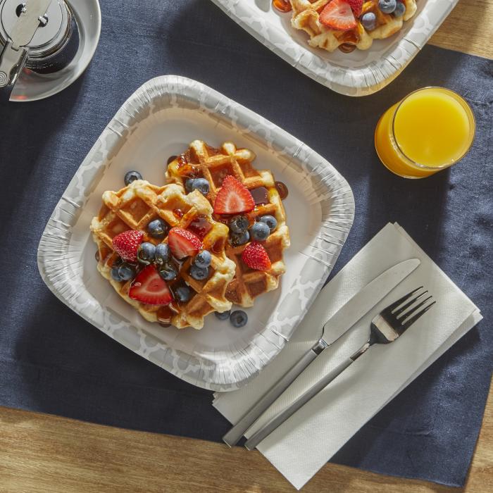 Waffles topped with blueberries and strawberries on a Hefty Extra Deep paper plate