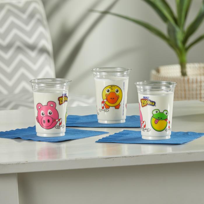 Three Zoo Pals Cups filled with milk sitting on a table