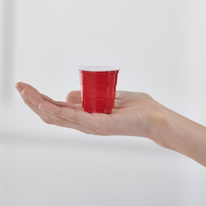 Hefty 2oz red party cup in a woman's hand to show its small size