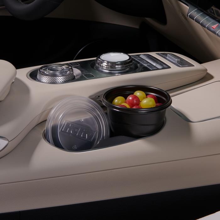 Hefty Multi-Purpose Cup sitting in a car cup holder filled with grapes
