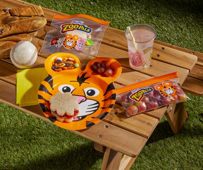 Outdoor picnic table set with a Zoo Pals plate, cup and storage bags