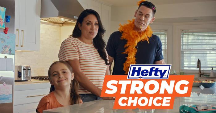john cena is a kitchen alongside a mother and daughter wearing an orange boa